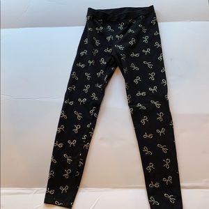 LIKE NEW leggings—black w/silver metallic bows